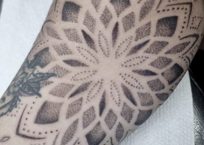 Fine line floral tattoo on forearm