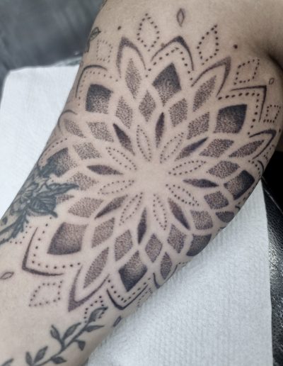 Fine line floral tattoo on forearm